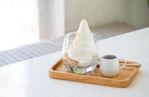 Affogato Espresso on wooden disk on the white table near windows in coffee shop, ice cream, cafe, copy space photo