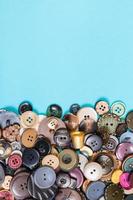 pile of various buttons on blue with copyspace photo