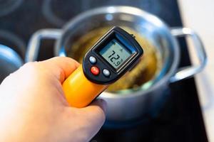 measuring temperature in water bath by thermometer photo