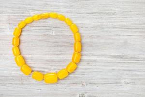 top view of antique yellow amber necklace on gray photo