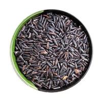 top view of raw black rice in round bowl isolated photo