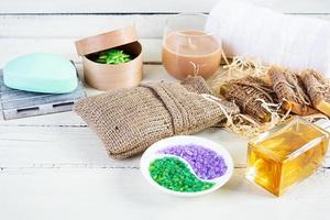 Different spa and bathroom products isolated on wooden background. Products for beauty treatments and body care photo