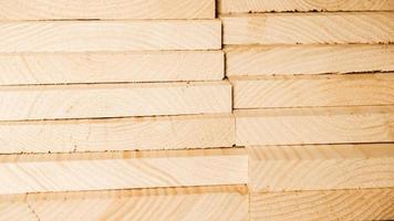 Stacked wooden carpentry boards from natural wood in a woodworking industry photo