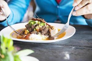 People eating spicy Northern Thai style noodle set - Thai food concept photo