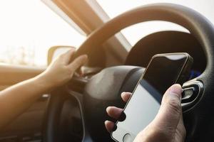 Lady using mobile phone while driving car dangerously photo