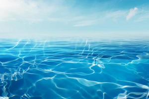 Blue sea or ocean water surface and underwater with sunny and cloudy sky photo