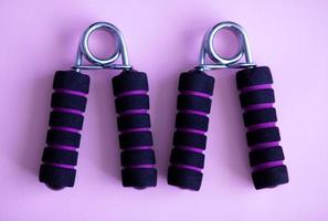 Hand grip strengthener for hand exerciser on a purple background photo