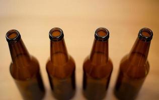 Four dark empty beer bottles photo