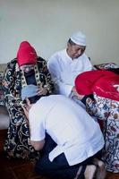 Asian muslim family during eid mubarak celebration. forgiving and apologizing each other. photo