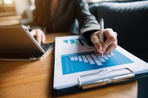 businessman working with digital tablet computer and smart phone with financial business strategy layer effect on desk photo