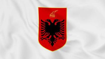 emblema nacional escudo de armas o símbolo de albania en bandera ondeante. Bucle suave de video 4k sin problemas