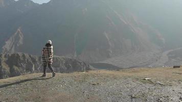 Caucasian woman stands excited on viewpoint in mountains sightseeing and travel in fall nature outdoors video
