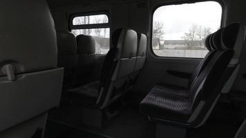 Empty seats in train with Vilnius tower view through window. Lithuania public railway transport concept. video