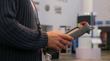 Man holding remote control for robotics arm for technowelding on industry video