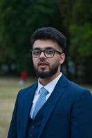 Young Businessman is posing at local park of Luton England UK photo