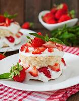 Sponge cake with cream and strawberries photo