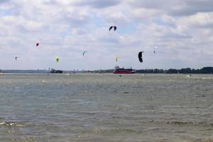 Lots of kite surfing activity at the Baltic Sea beach of Laboe in Germany on a sunny day. photo