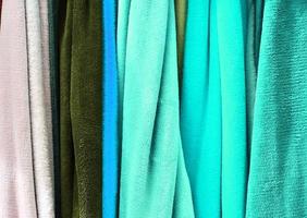 Detailed close up view on samples of cloth and fabrics in different colors found at a fabrics market photo