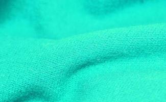 Detailed close up view on samples of cloth and fabrics in different colors found at a fabrics market photo