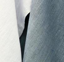 Detailed close up view on samples of cloth and fabrics in different colors found at a fabrics market photo