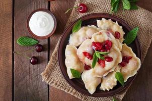 Delicious dumplings with cherries and jam. photo