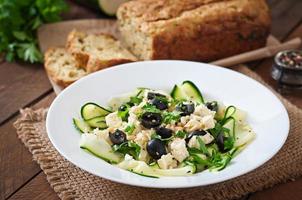 Zucchini salad with feta, olives and pine nuts photo