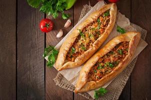 Turkish pide traditional food with beef and vegetables photo