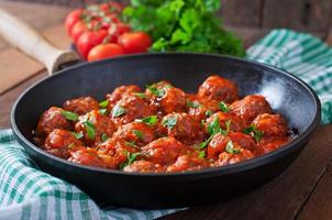 Meatballs in sweet and sour tomato sauce. photo