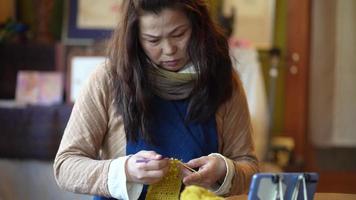 Woman knitting at home video