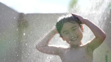 Boy frolicking in the shower video