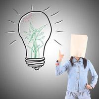 Businesswoman drawing and idea lamp photo