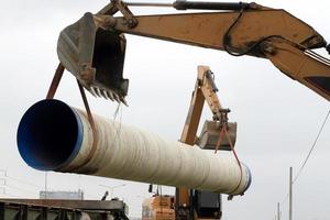 Specialized equipment for placing large diameter pipe in a trench photo