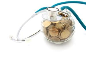 stethoscope with coins in the savings, financial concept photo