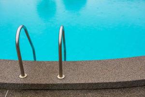 Swimming pool with stair at hotel close up photo