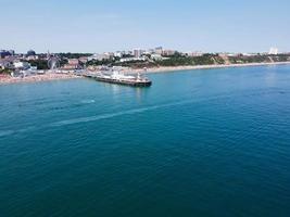 High Angle Footage and Aerial view of Ocean with High Speed Boats, People are having fun and enjoying hottest weather at Bournemouth Beach Sea Front of England UK. photo