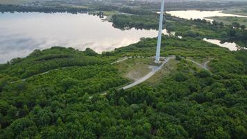 High Angle Aerial View footage over Windmill Wind Turbine at Stewartby Lake of England at Sunrise photo