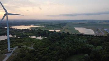 High Angle Aerial View footage over Windmill Wind Turbine at Stewartby Lake of England at Sunrise photo