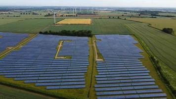 Aerial footage High Angle view of Green Energy natural Generators Sources of Wind turbines and solar panels Farms at England UK photo