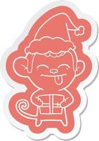 funny cartoon  sticker of a monkey with christmas present wearing santa hat vector