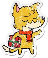 distressed sticker of a friendly cartoon fox with christmas present vector