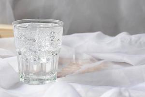 Soda water with ice in a clear glass. Copy space. photo