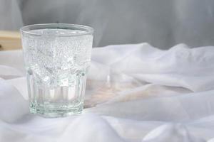 Soda water with ice in a clear glass. Copy space. photo