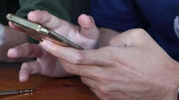 Close-up of a man's hand playing with a smartphone. With a sensitive focus video