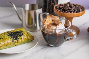 Drip coffee in a bag, drip in a clear coffee mug. photo