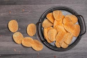 Potato chips in a vintage black tray photo