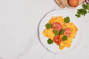 Oil-free tomato omelette in a white plate. Healthy food ideas for weight loss. photo
