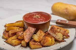 Salt-grilled potatoes with tomato sauce. Fast food restaurant photo