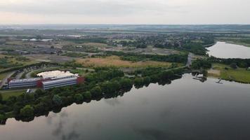 High Angle Aerial View footage over Windmill Wind Turbine at Stewartby Lake of England at Sunrise photo