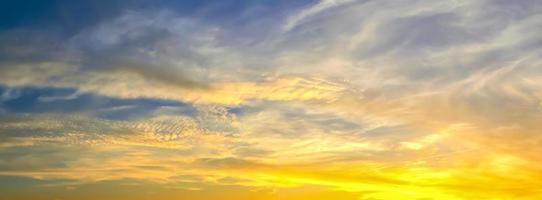 Beautiful high resolution panorama of orange and red sunset clouds in the evening sky photo