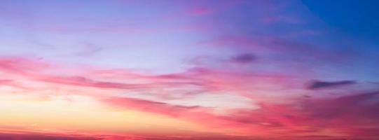 Beautiful high resolution panorama of orange and red sunset clouds in the evening sky photo